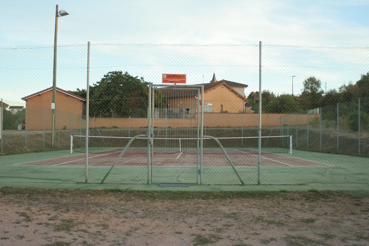 Terrain de tennis de Vendranges, entouré de son grillage, avec filet et éclairage.